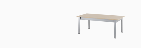 Angled view of an Easton Coffee Table with a clear on ash laminate top and metallic silver legs.