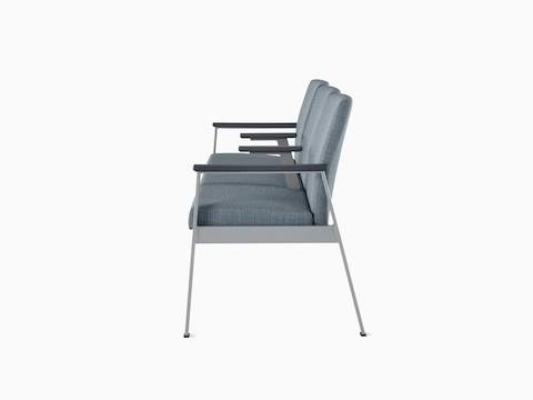 Side view of Easton Multiple Seating with three seats, intervening arms, blue upholstery, metallic silver frame and grey arm caps.