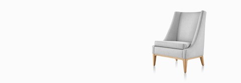 Angled front view of an Iris Lounge Chair in a light gray textile with an oak base.