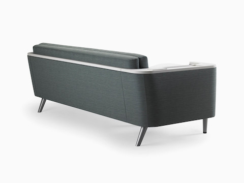 A Nemschoff Palisade Flop Sofa in dark gray textile with white solid surface arms caps, viewed from the back.