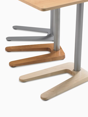 A close up of three Palisade Mobile Table bases in a variety of finishes including ash, walnut, and painted sliver.