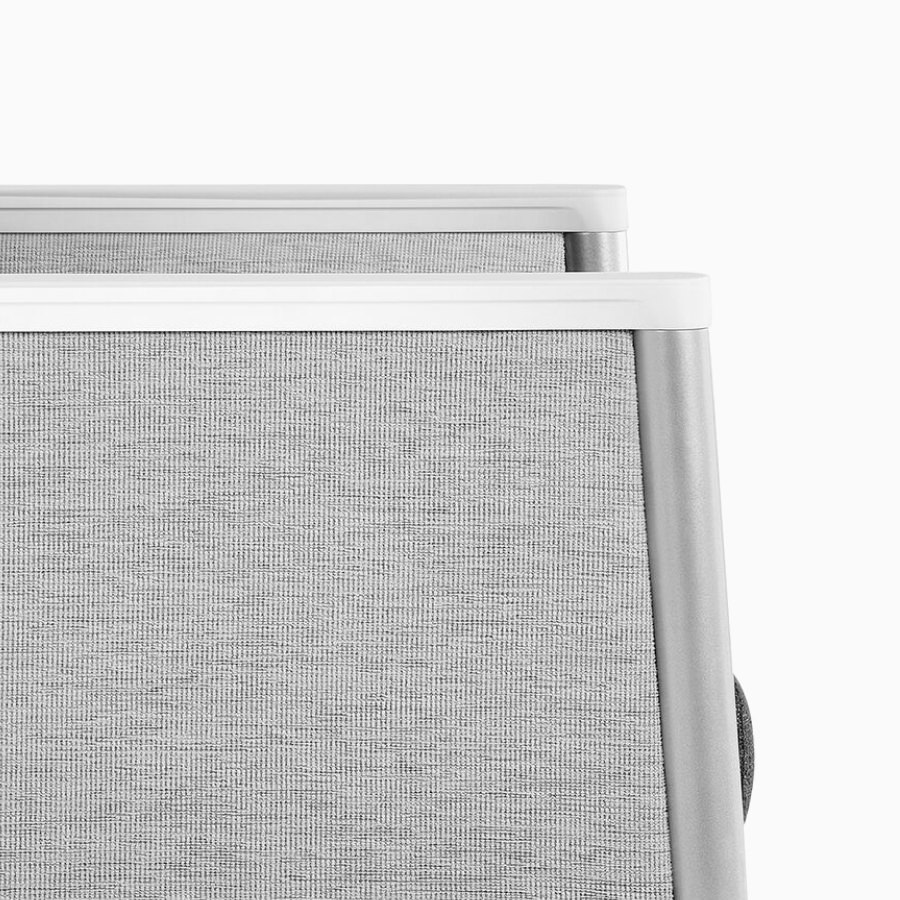 Detail of Nemschoff Palisade Multiple Seating in a gray upholstery and white solid surface arm caps.