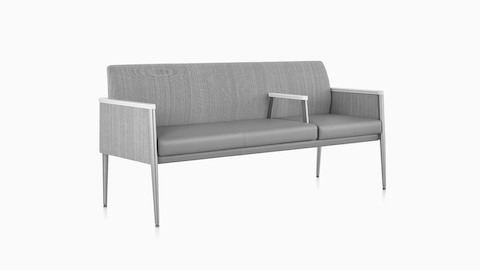 Three-quarter view of Palisade Plus Seating three-seater in gray fabric.