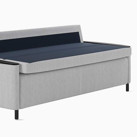 A Pamona Flop Sofa in light gray upholstery with the sleep surface open, viewed from an angle.