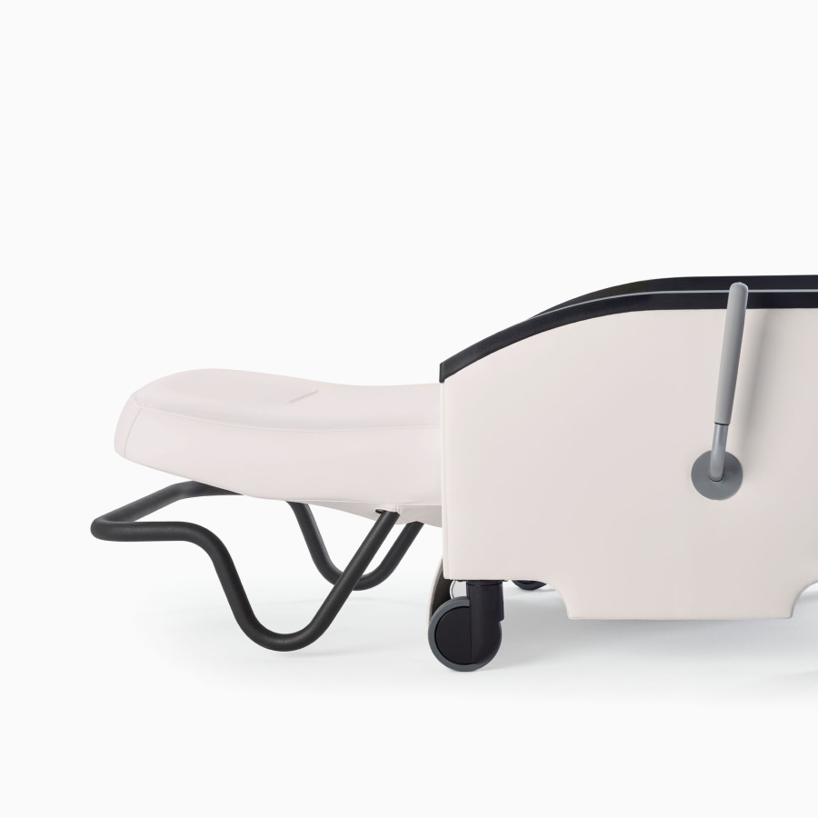 A completely flat, reclined Nemschoff Prísto Recliner in white fabric, viewed from the side.