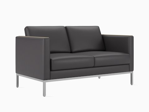 A Riva 2-seat sofa in a gray-black textile, viewed at an angle.
