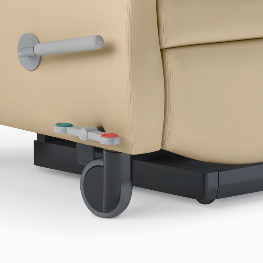 Close-up of a recline lever and central brake and steer control on a Nemschoff Serenity Recliner.
