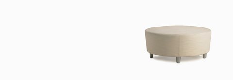 A Steps Lounge System Ottoman in a light-colored textile.