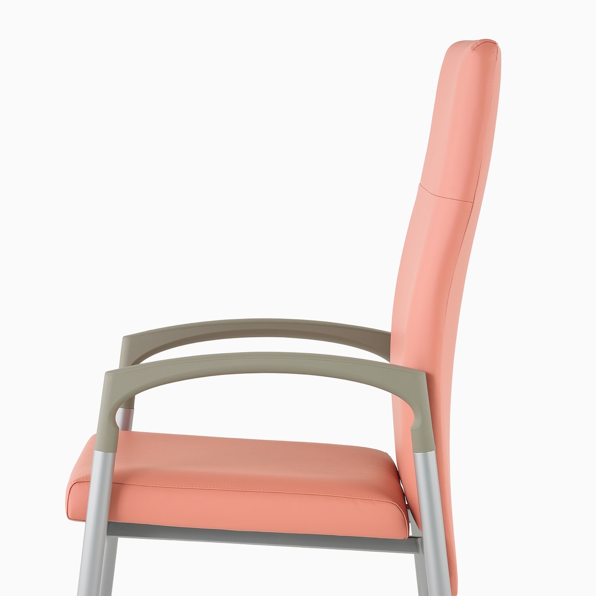 Side view of a high-back Valor Patient Chair in a salmon pink upholstery and silver frame with pewter armcaps.