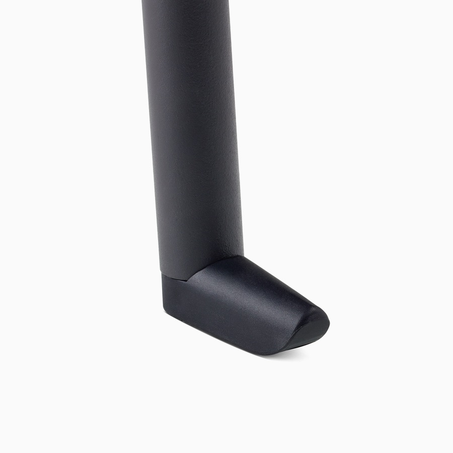 A detail of the wall saver glide on a Valor Side Chair in a black finish.