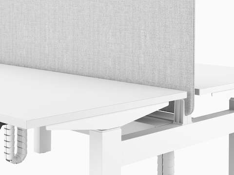 A close-up section of Nevi Link showing a back-to-back gray fabric screen mounted between two white desks.
