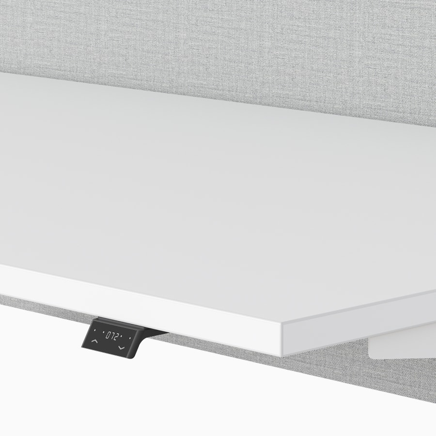 An electronic switch on a white Nevi Sit-Stand Desk viewed at an angle.