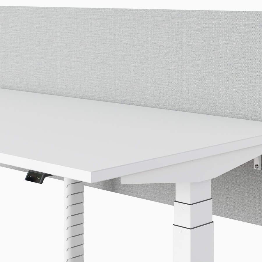 A close-up view of the privacy screen on a Nevi Sit-Stand Desk, with an umbilical providing vertical cable management.