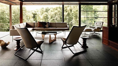 A Noguchi Table with a white ash base anchors a residential setting filled with mid-century modern pieces. 