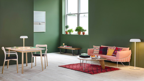A residential setting featuring Ode table and sofa lamps, along with a Noguchi Rudder Table and salmon-colored Wireframe Sofa.
