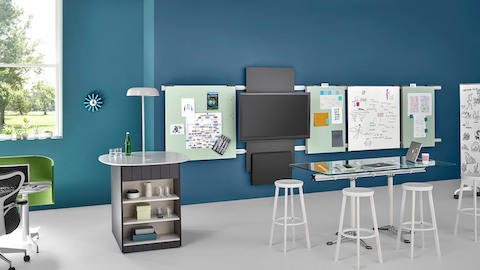 A collaboration area that includes a white Ode Lamp mounted on the surface of a refreshment center.