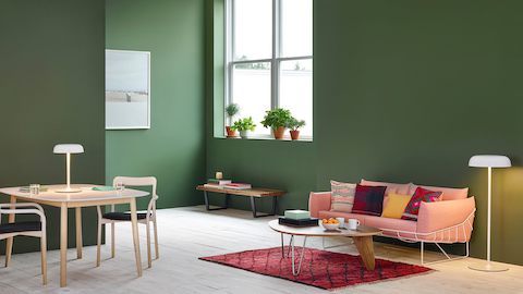 A residential setting featuring Ode table and sofa lamps, along with a Noguchi Rudder Table and salmon-colored Wireframe Sofa.