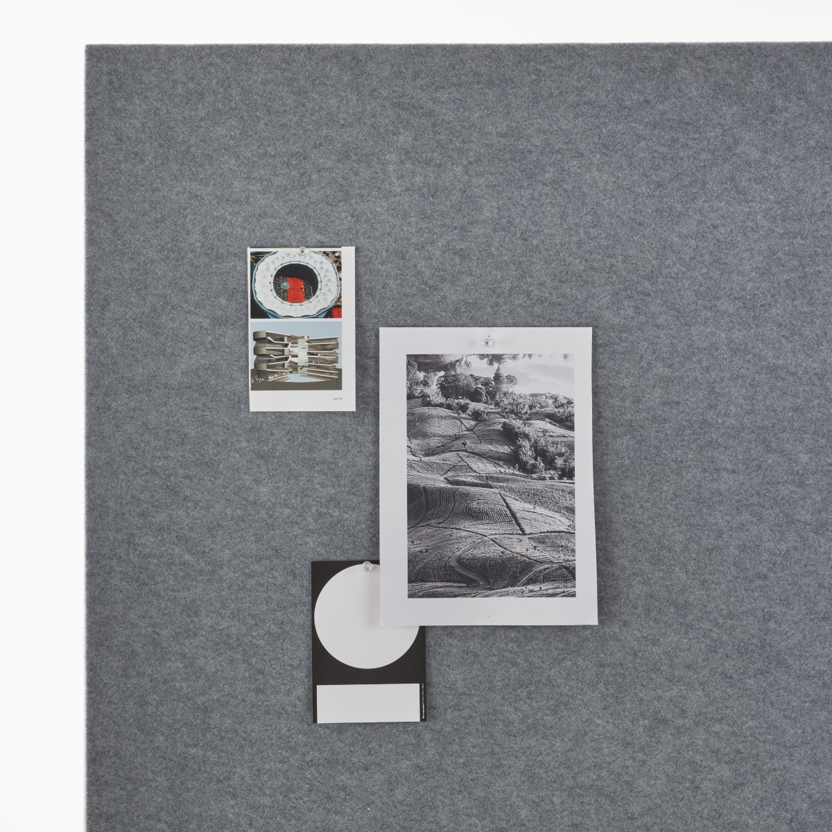 Detail of a grey OE1 Curved Screen with documents tacked up.