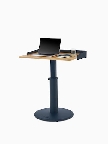 OE1 Sit-to-Stand Table with green base and white surface with green wrap screen at a standing height, viewed from a front angle.
