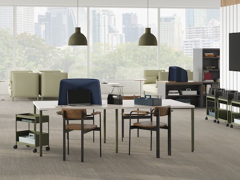 Open floor collaborative and focus space with project tables, mobile storage, privacy hoods and lounge seating.