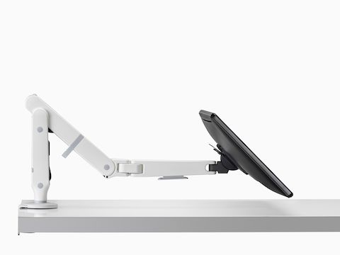 Side view of an adjustable Ollin Monitor Arm supporting a monitor at a low angle.