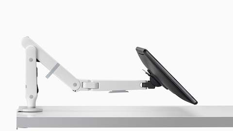 Side view of an adjustable Ollin Monitor Arm supporting a monitor at a low angle.