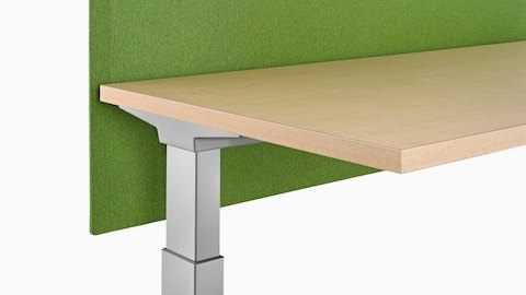 Vista cercana de una pantalla verde Pari adherida a la superficie fijada a una superficie de trabajo ajustable en altura.