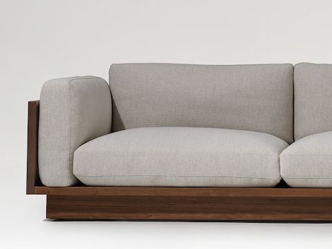 Front view of the Pawson Drift sectional with walnut frame and grey cushions