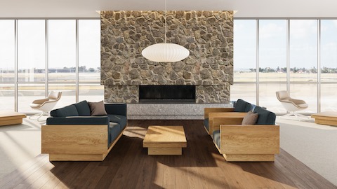 Pawson Drift Coffee Table with walnut finish and stone top, with Pawson Drift Sofa and Lounge Chairs with walnut finish and green upholstery.