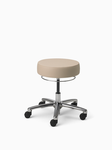 A Physician Stool in tan fabric with aluminum base and polyurethane casters.