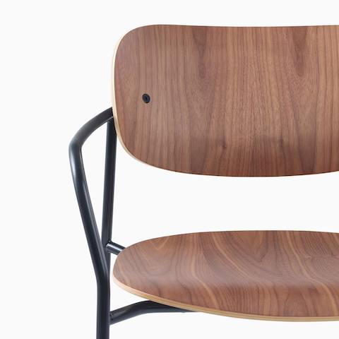 Detail image of Portrait Chair with Walnut seat and back, and black frame with arms.