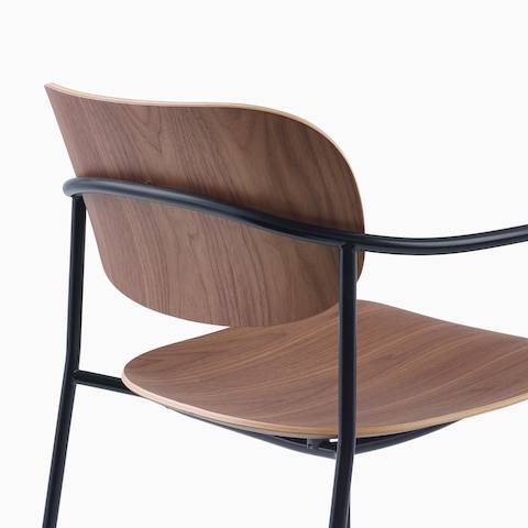 Detail image of Portrait Chair with Walnut seat and back, and black frame with arms.