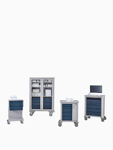 Group of Procedure and Supply Carts including L Cart, double-wide cart, supply cart, and technology cart in light gray body with midnight blue drawers.