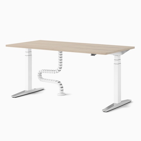 A single Ratio height adjustable desk with a wooden worktop and floor to work surface cable umbilical.