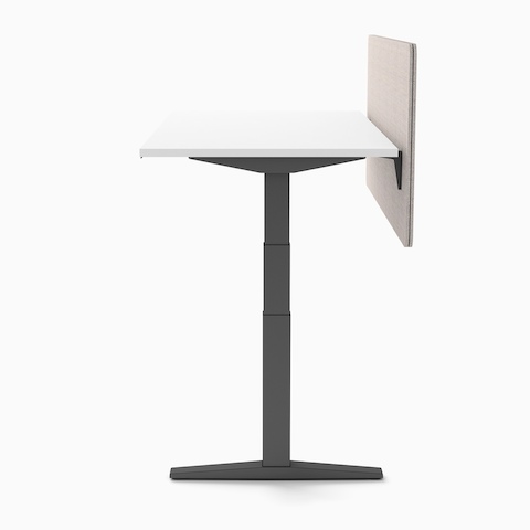 End view of single Ratio height adjustable desk with graphite understructue, white work surface, and frameless beige privacy screen.