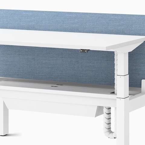 Close up view of a Ratio height adjustable desk with a high capacity tray.