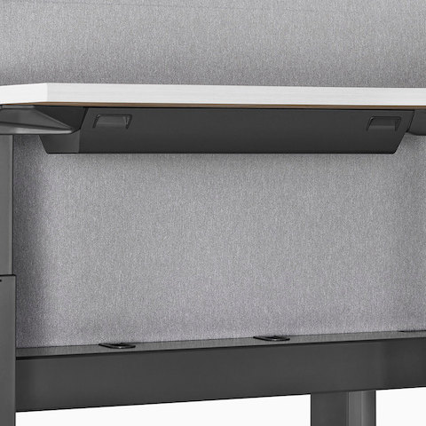 A close-up view of a Renew Link standing desk system's high-density cable tray.