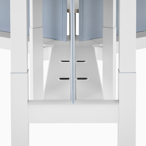 A close-up view of a Renew Link standing desk system's enhanced cable trough.