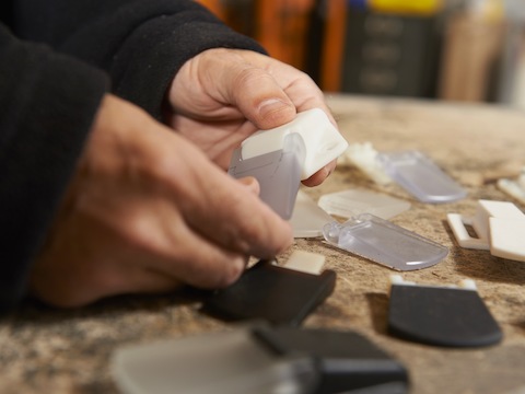 Close-up of Brian Alexander's hands examining an intuitive paddle.