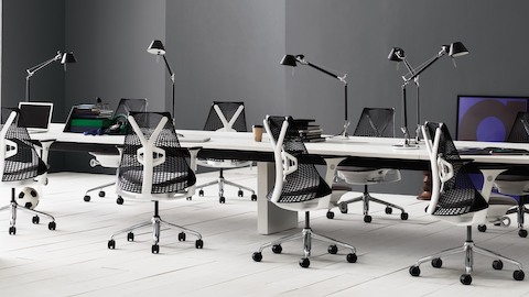 Black Sayl office chairs in a benching work environment.