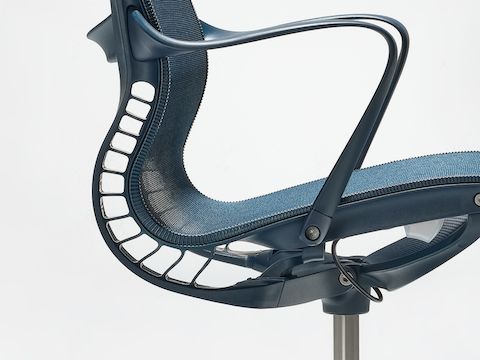 A close-up side view of a Setu chair with arms in nightfall blue. 