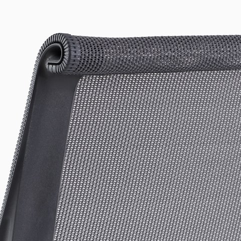 A close-up view of the suspension back of a Setu chair in gray.