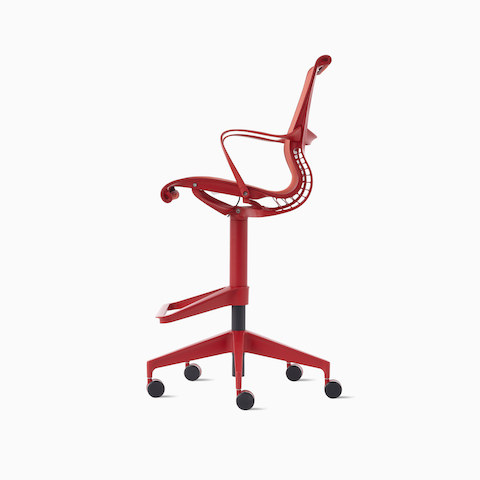 A side view of a Setu Stool with fixed arms in red.