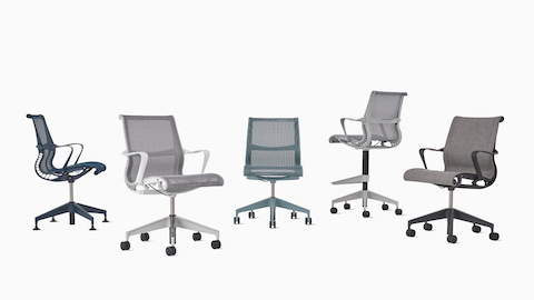 A group of five Setu chairs including a Setu Side Chair with arms in blue, a Setu Chair with white arms and gray suspension, an armless Setu Chair in light blue, a Setu stool in light gray, and an upholstered Setu Chair with arms in gray.