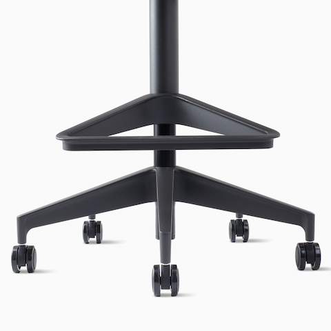 A close-up view of a footrest on a Setu Stool in dark gray.