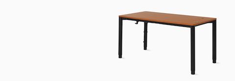 Angle view of a four leg height-adjustable table with a dark woodgrain surface and black base.