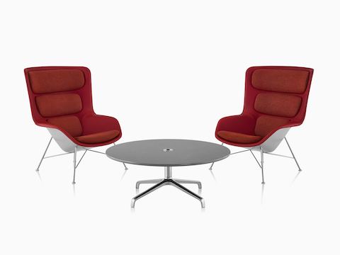 Two red and gray Striad High-Back Lounge Chairs with Striad Table with concrete quartz surface.