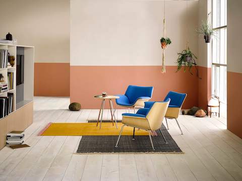 Collaboration space featuring blue Swoop lounge chairs and a small round table.