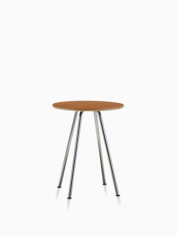 A round Swoop table with a medium wood finish.