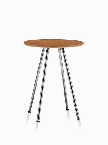 A round Swoop table with a medium wood finish. Select to go to the Swoop Lounge Furniture product page. 